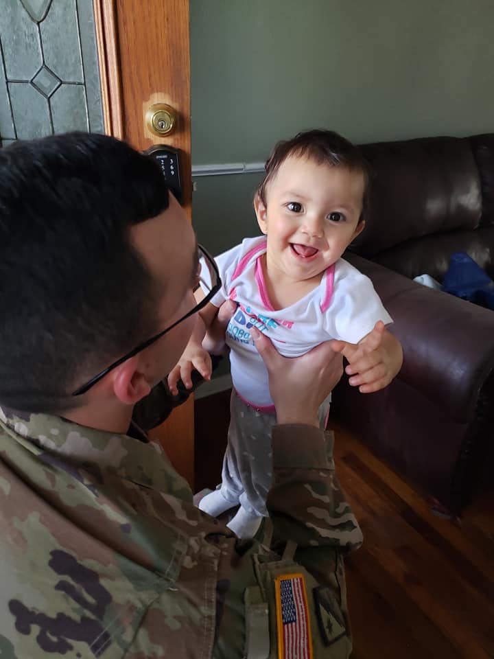Sgt. Matthew Taylor with baby, Lily after returning home to Mesquite, wife Amanda Taylor