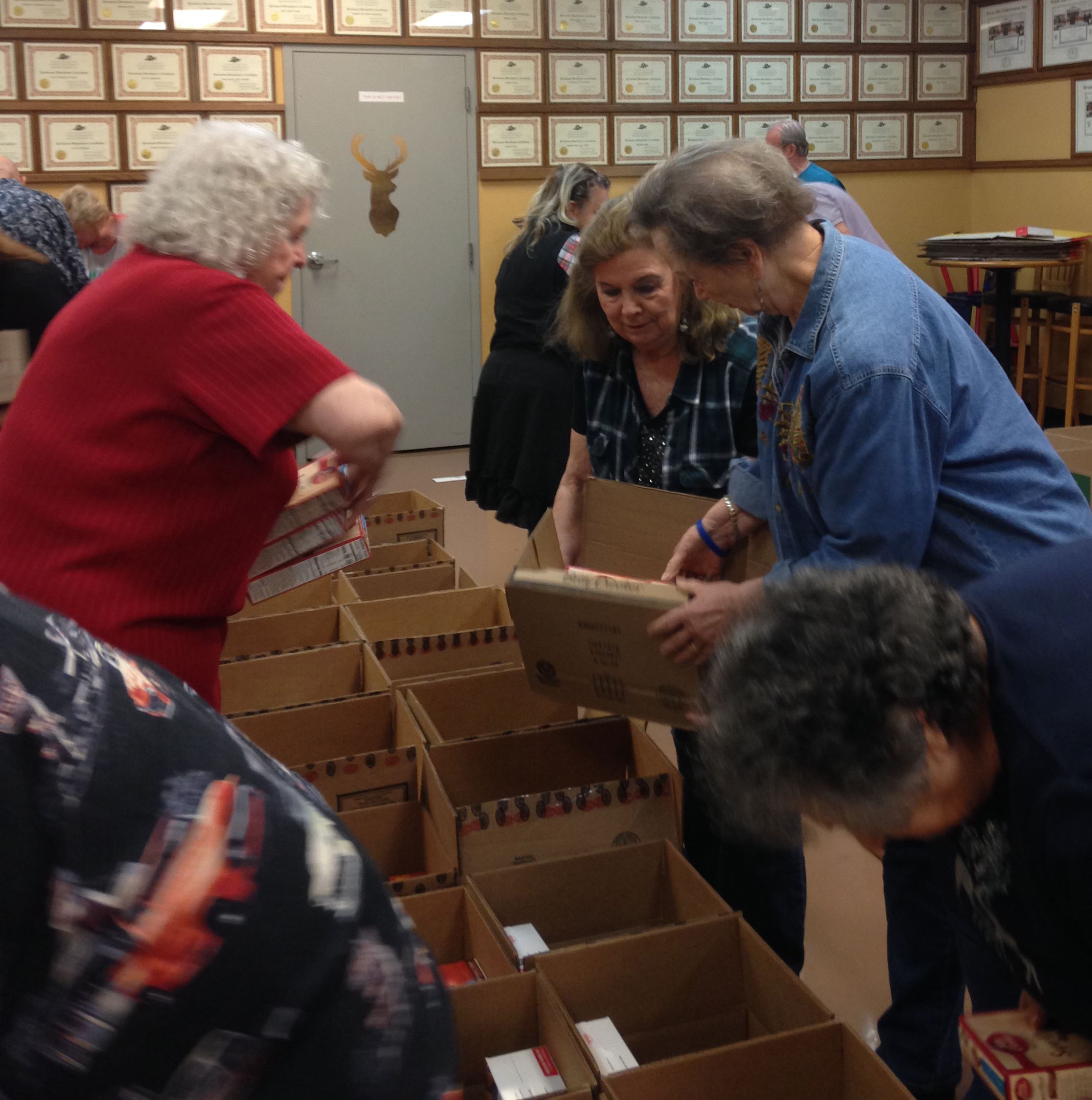 Mesquite Elks Lodge Auxiliary ladies pack boxes of food 