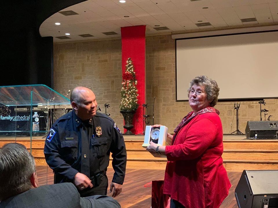 Chief Cato presents Barbara Dunn with Volunteer of the Decade award