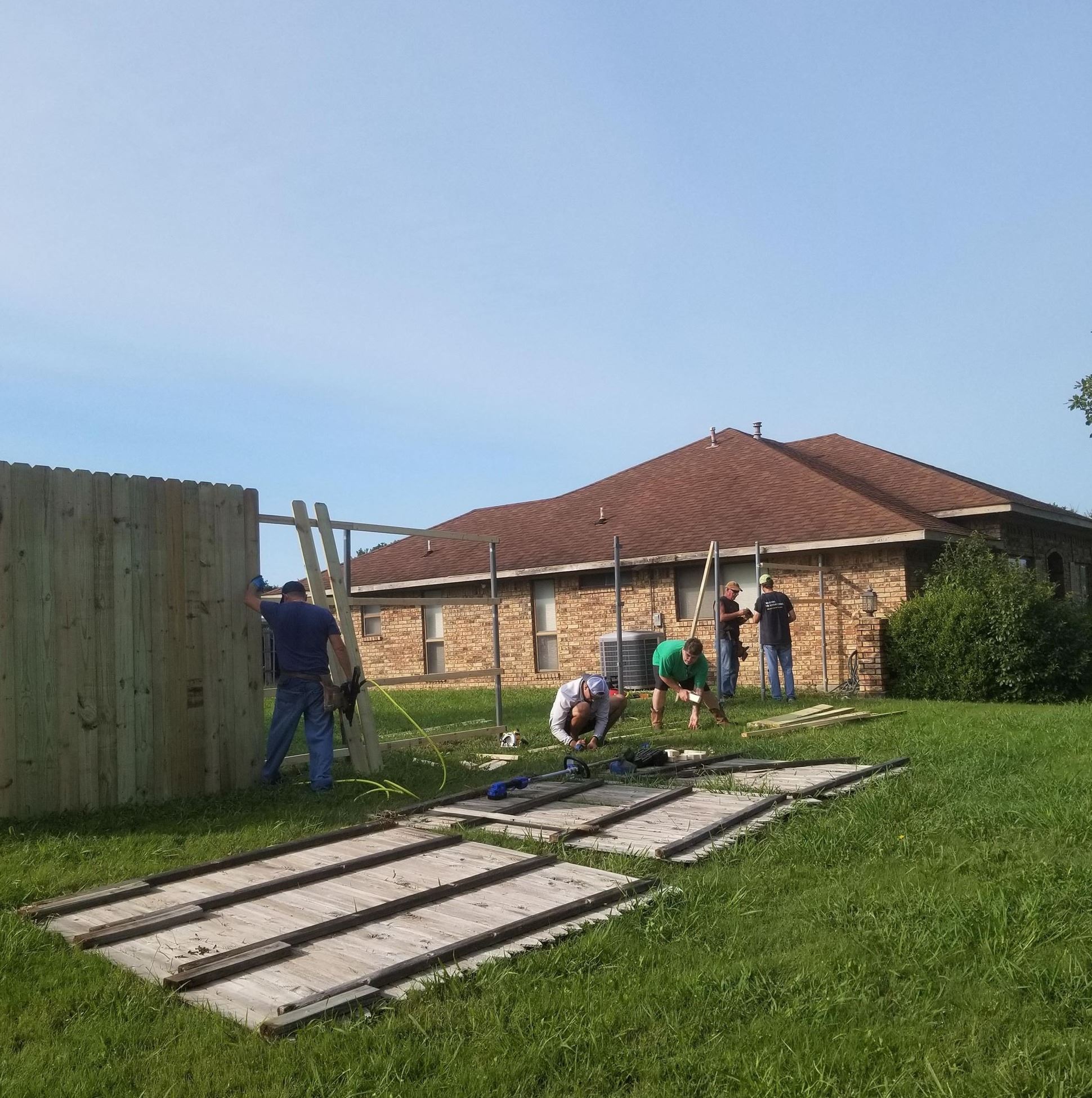 Neighbors building fence for Ms. Wilma