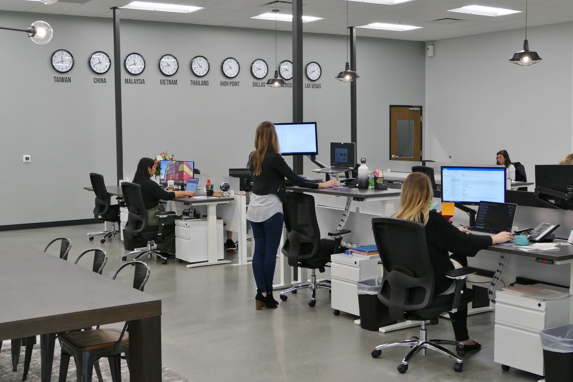 Clock wall and team working at Elements International