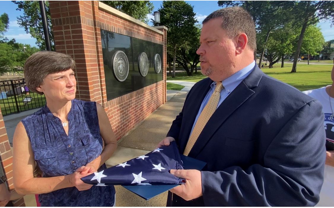 Mayor Archer presents flag to Susan Lawson