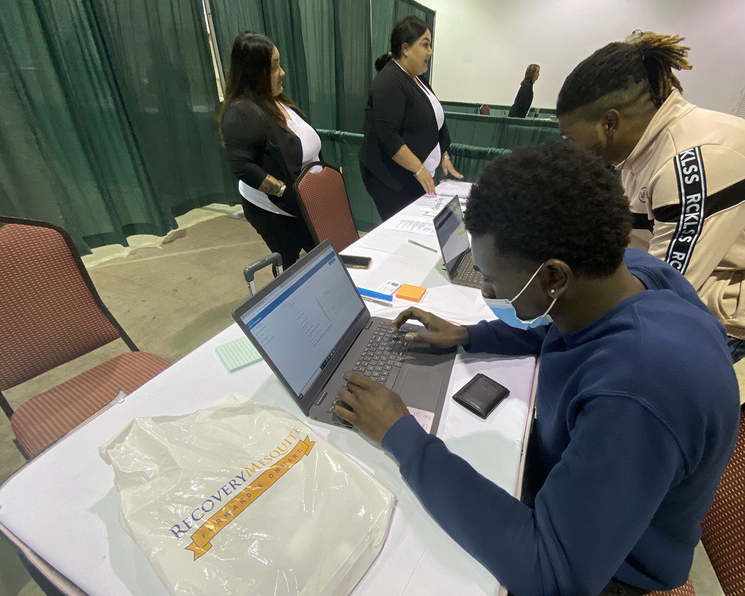 6-9-21 Mesquite Job Fair - job seeker completes application on laptop - Mesquite TX