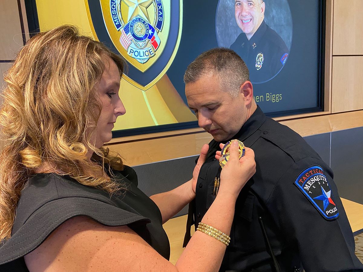 7-30-21 Mesquite Police Captain Stephen Biggs has badge pinned by his wife during promotional ceremo
