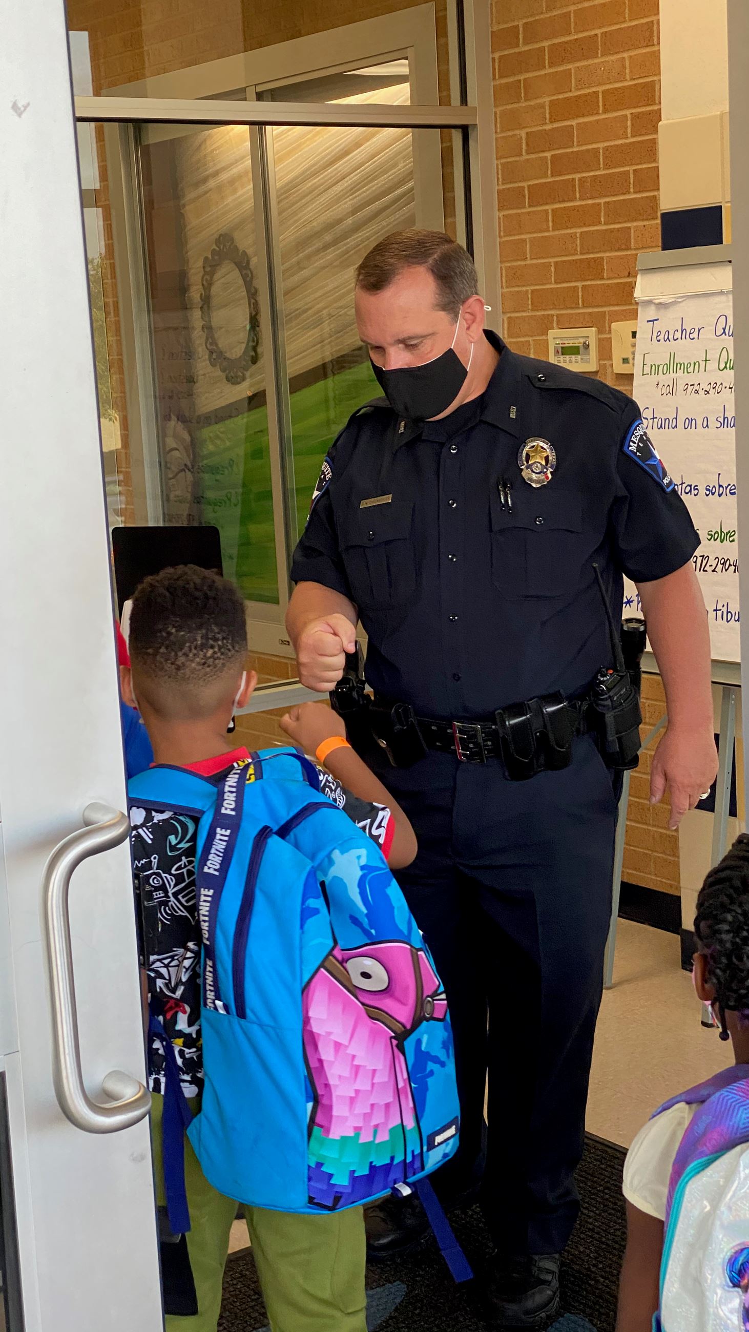 Officer Ehrenberger first bumps student