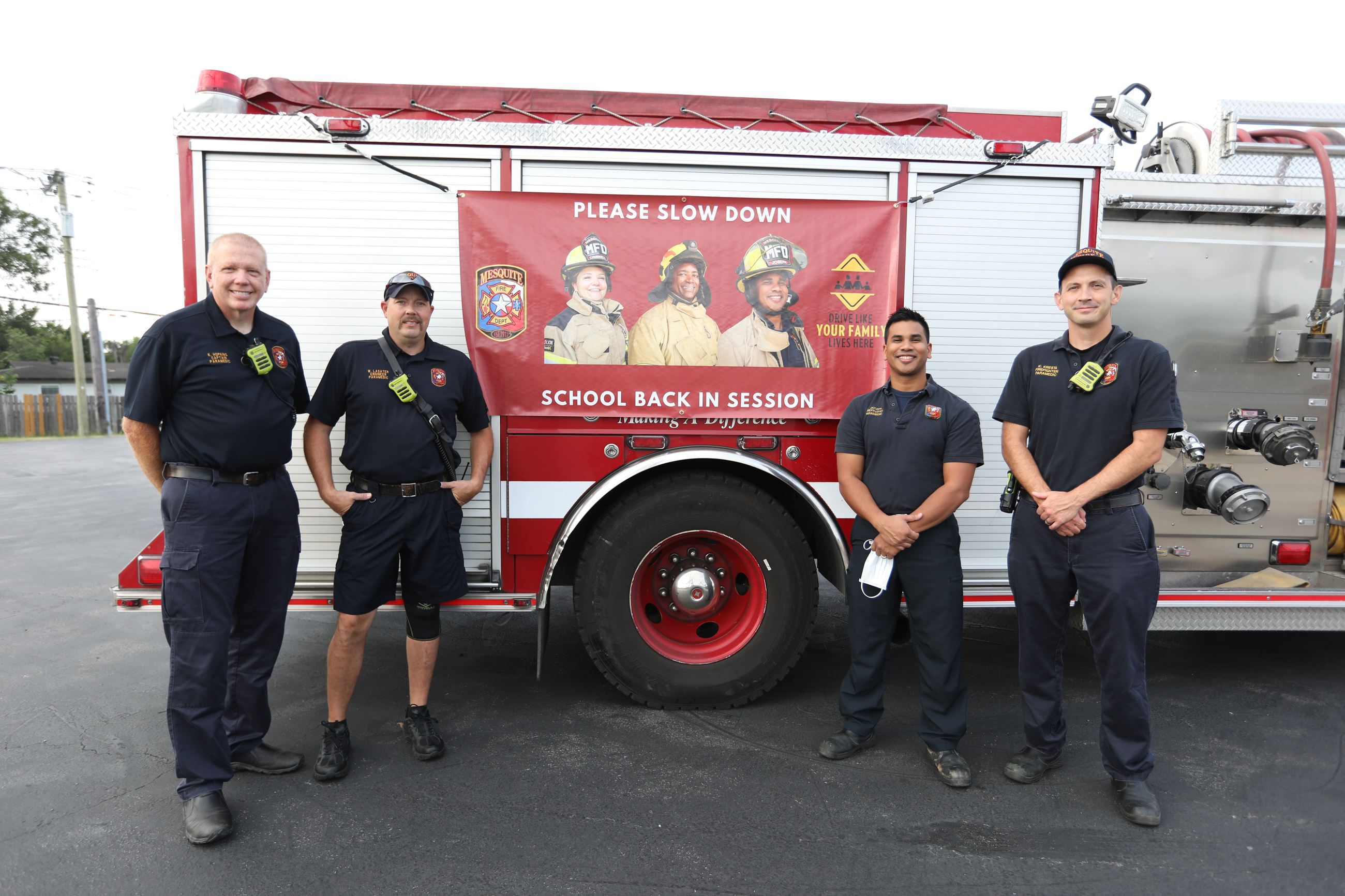 Firefighters next to engine