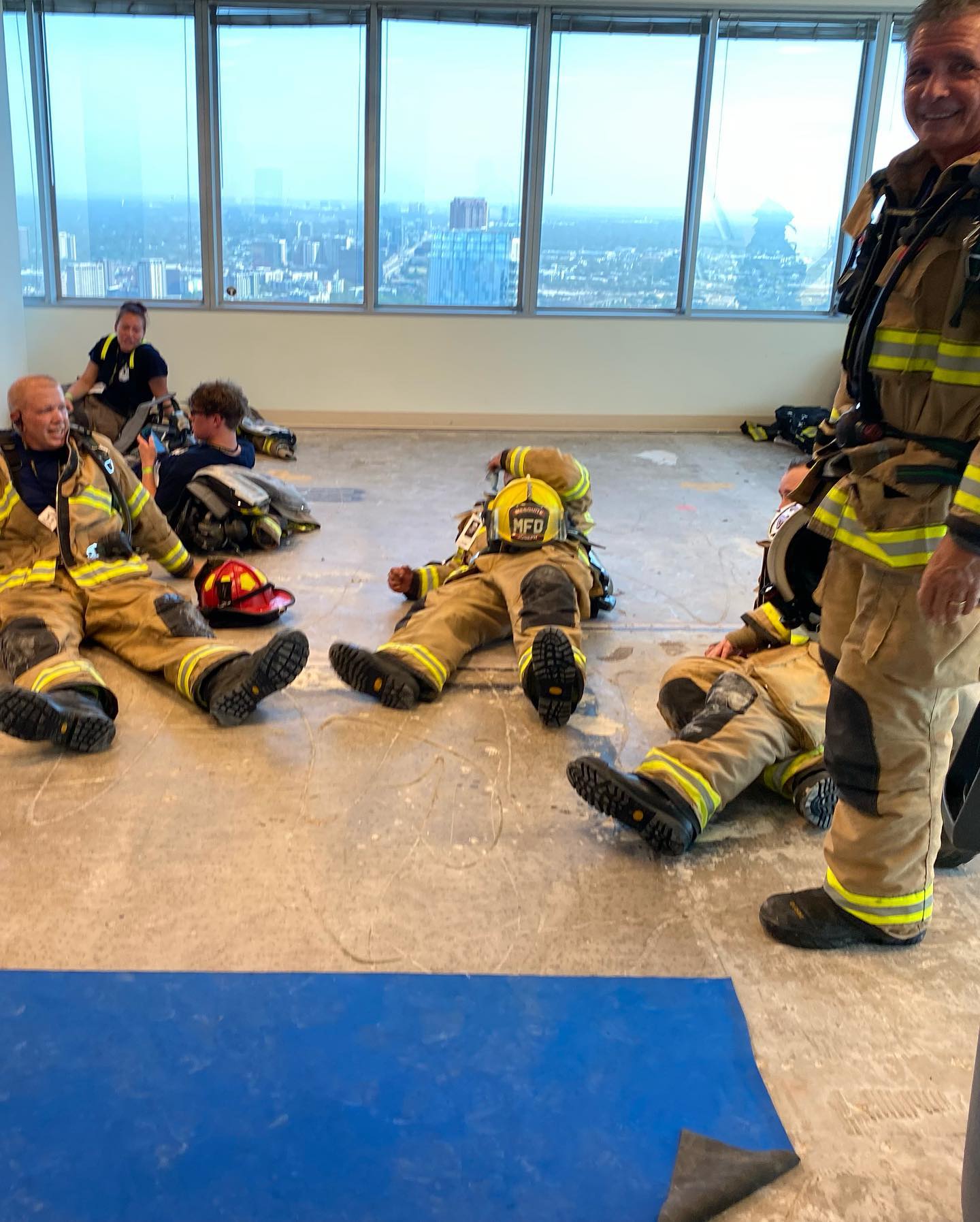firefighters laying down after climbing stairs