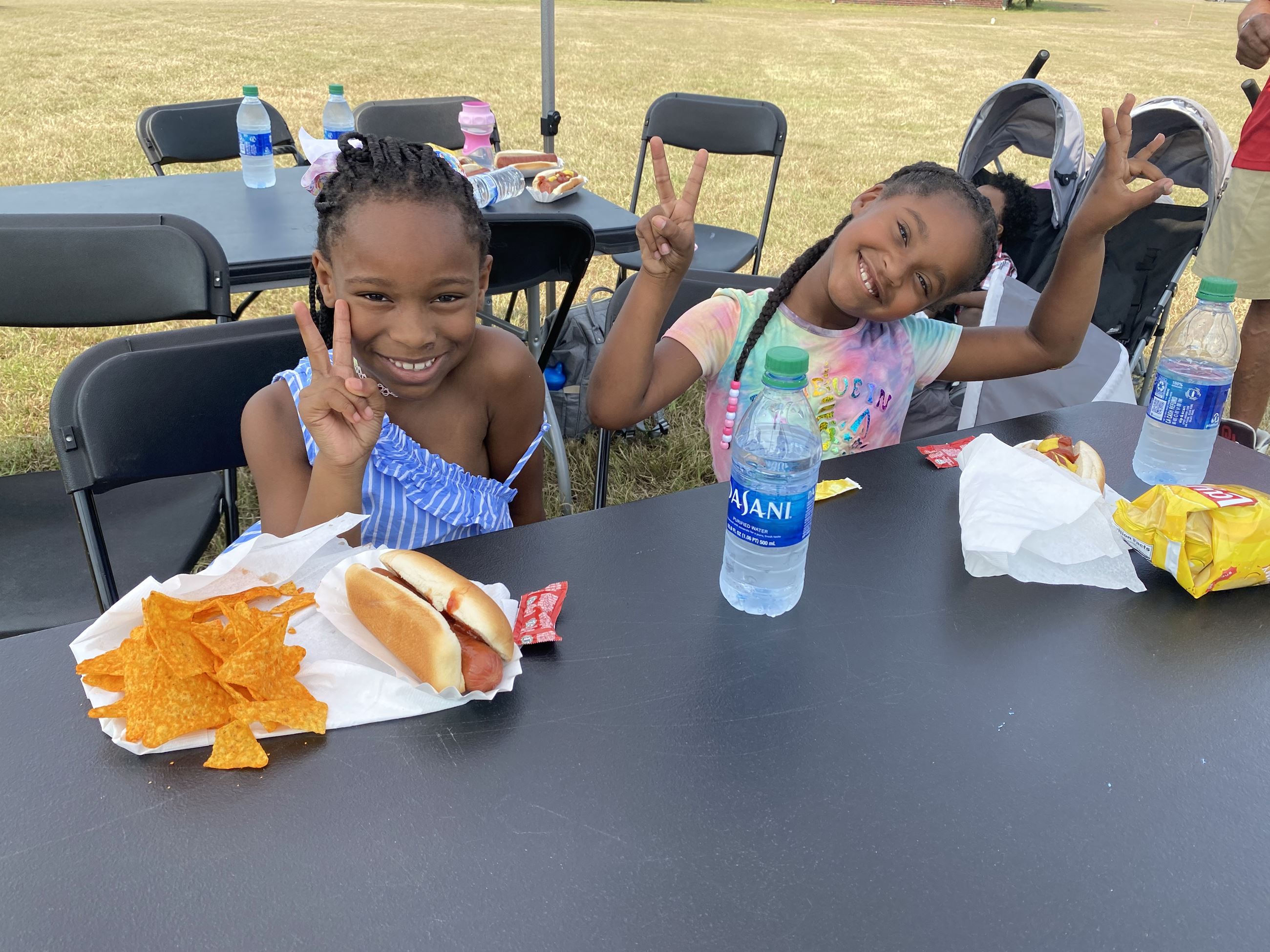 little girls pose and enjoy their lunch
