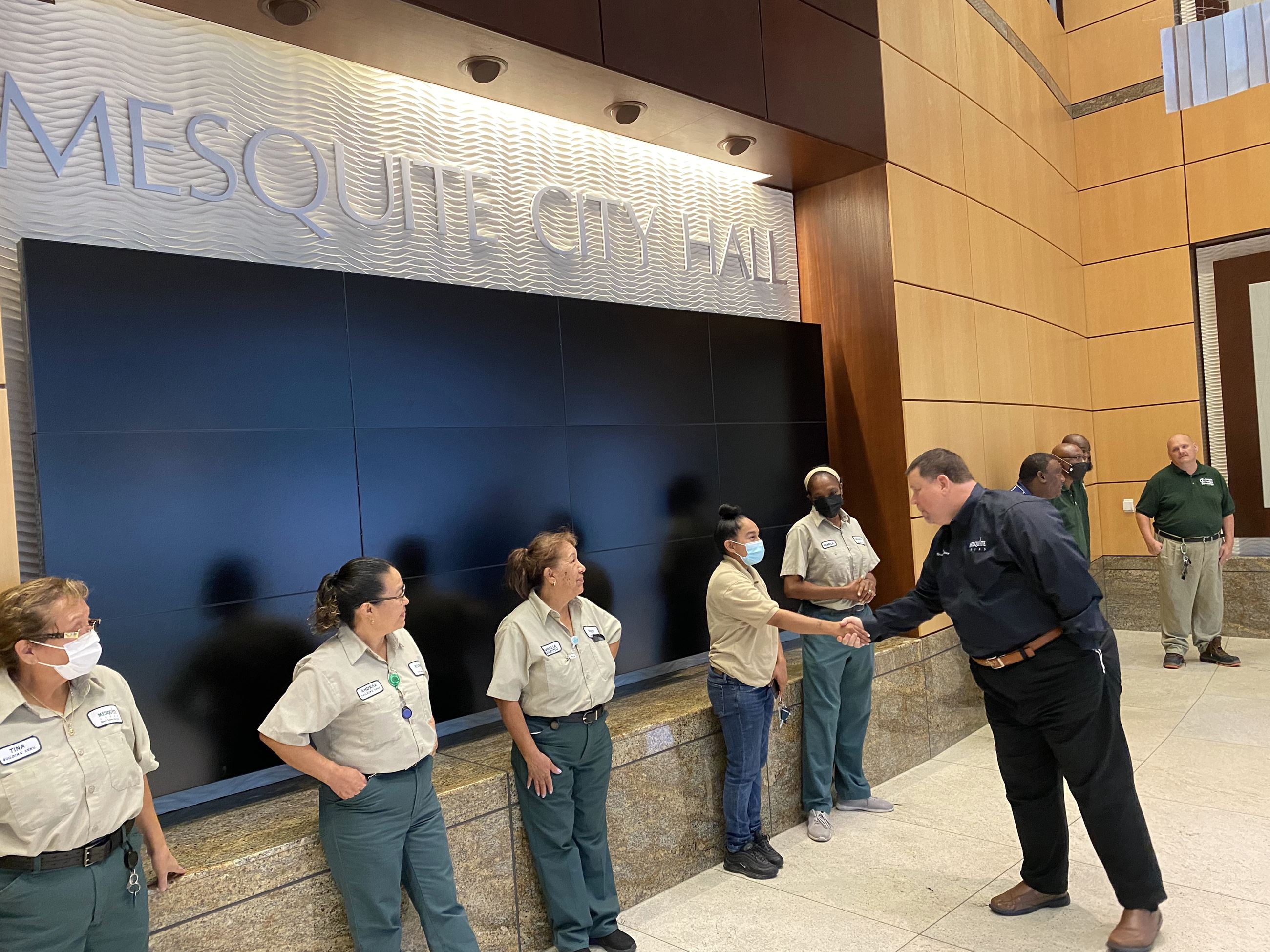 Mayor Archer shakes workers hands