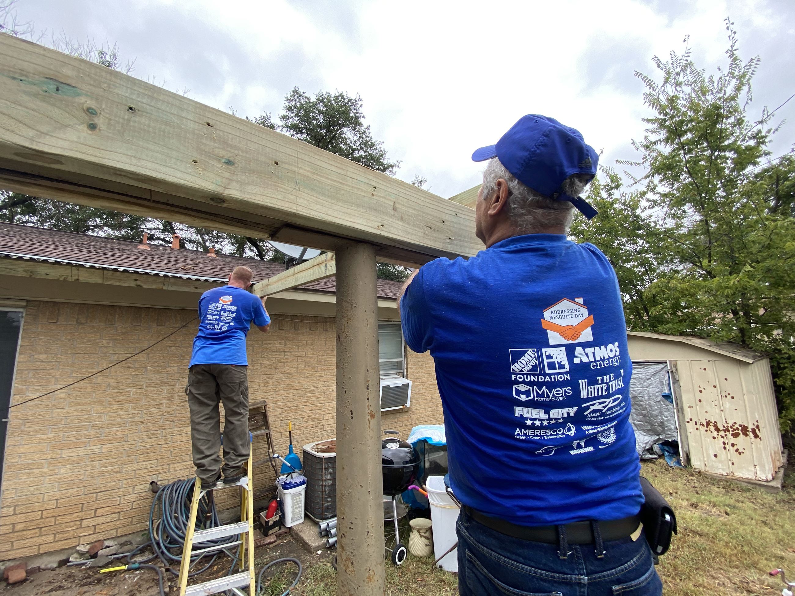 volunteers build porch cover