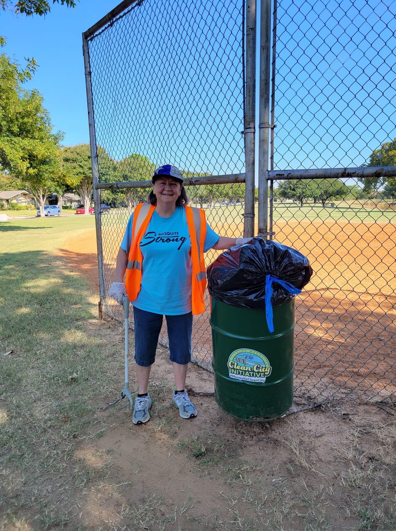 woman cleaning at trash bash