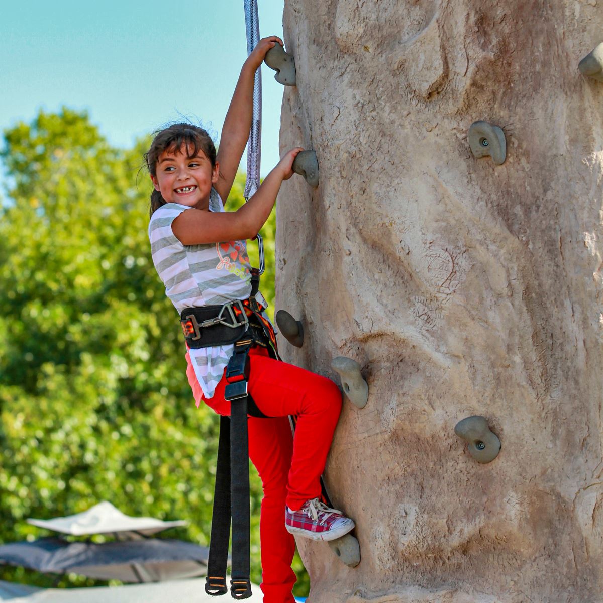 Girl climbing rock wall at PumpkinFest - Mesquite, TX
