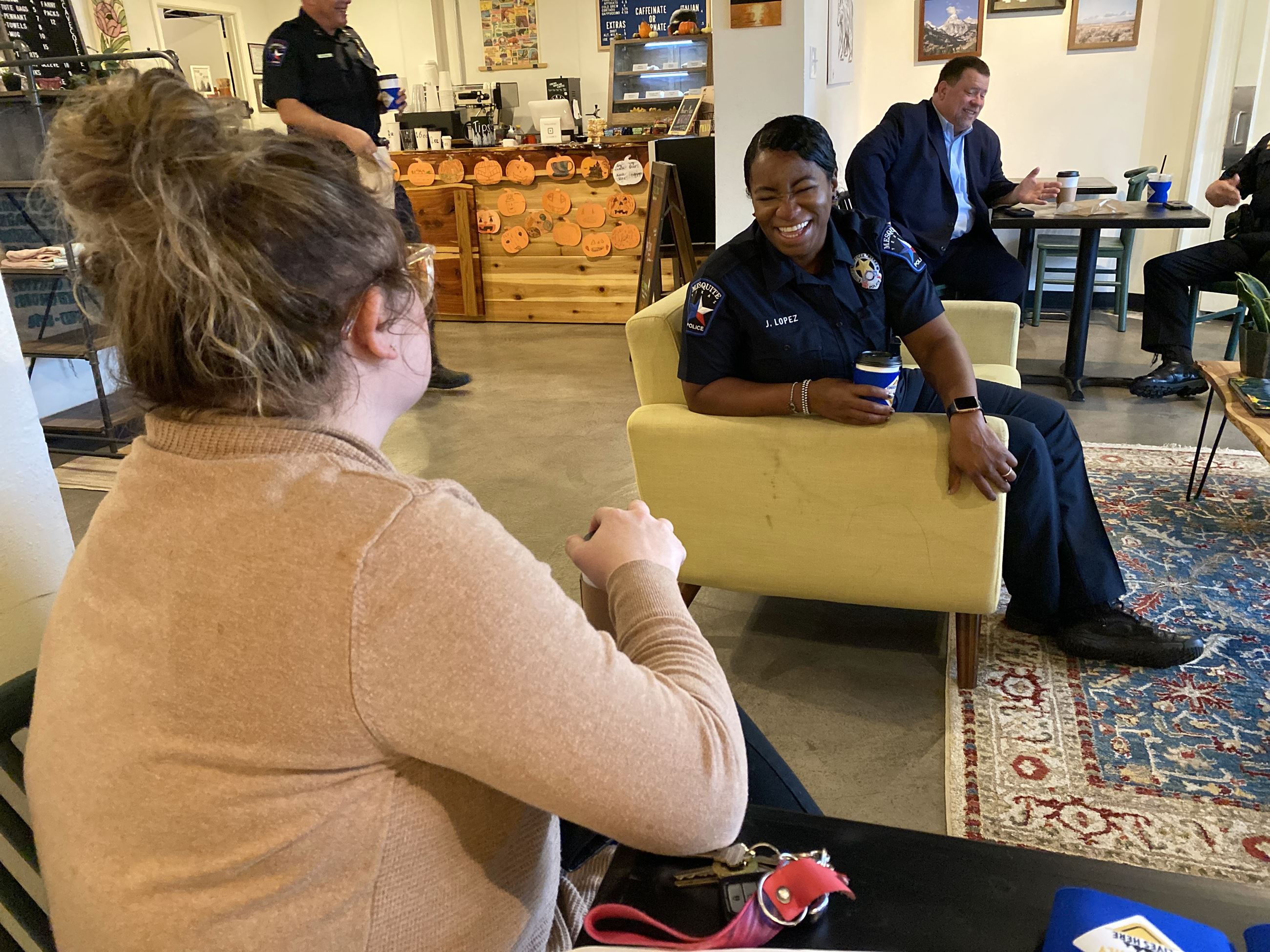 coffee with a cop, officer talks to woman